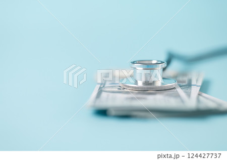Stethoscope symbolizes essential medical care provided within health care system, health insurance plays crucial role in financing treatment and medicine to disease, concept of health management. Stethoscope symbolizes essential medical care provided within health care system, health insurance plays crucial role in financing treatment and medicine to disease, concept of health management. 124427737