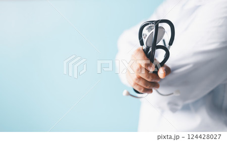 Professional doctor, equipped with a stethoscope, provided exceptional health care at the clinic, skilled surgeon performed critical operations at the hospital, ensuring comprehensive medical care. 124428027