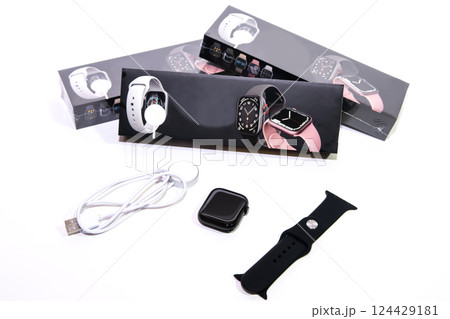 Black smart watch bracelet and charger on white background. 124429181