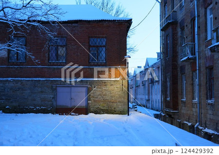A Quiet Winter Alleyway adorned with beautiful Snow at Dusk, capturing serene ambience A Quiet Winter Alleyway adorned with beautiful Snow at Dusk, capturing serene ambience 124429392