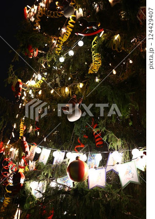 A beautifully festive Christmas Tree adorned with colorful ornaments and sparkling lights A beautifully festive Christmas Tree adorned with colorful ornaments and sparkling lights 124429407