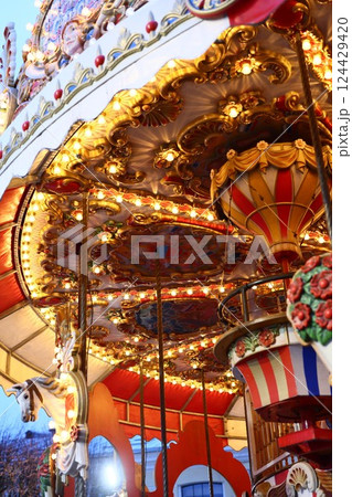 A Beautifully Vibrant Fairground Carousel Bathed in Colorful, EyeCatching Lights A Beautifully Vibrant Fairground Carousel Bathed in Colorful, EyeCatching Lights 124429420