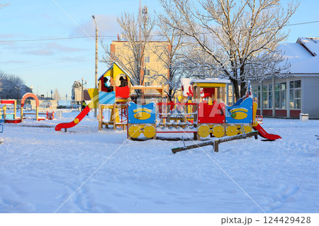 A Vibrant, Colorful Playground Set Alongside a Beautiful, Snowy Winter Landscape Scene 124429428