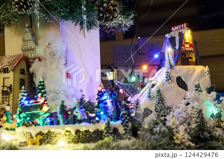 A delightful Holiday Village adorned with enchanting Snow and a mesmerizing Lights Display 124429476