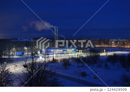A mesmerizing Winter Industrial Landscape portrayed at Night featuring Smoke Emission effects 124429509