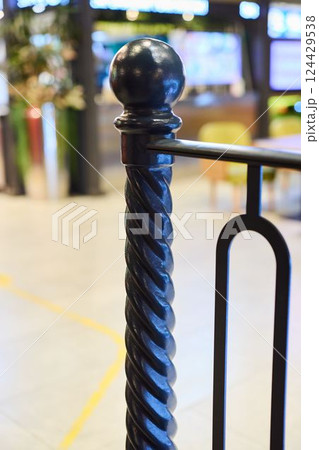 The Elegant Black Twisted Railing Post Amidst a Chic and Modern Interior Setting 124429538