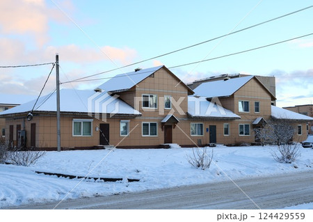 A Beautiful SnowCovered Residential Area in Winter with Scenic Views of the Landscape 124429559