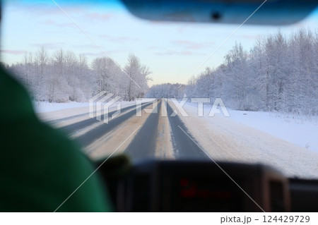 Embarking on a Scenic and Enchanting Winter Drive Through a Beautiful, SnowCovered Landscape 124429729