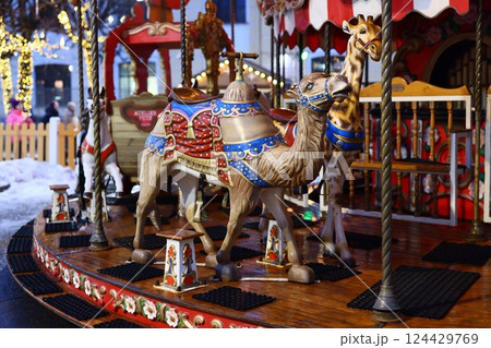 A Vibrant and Colorful Carousel Featuring a Camel and Other Beautifully Decorated Animals 124429769