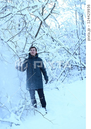 Individual enjoying the serene beauty found in a Winter Wonderland a natural tranquil escape Individual enjoying the serene beauty found in a Winter Wonderland a natural tranquil escape 124429936