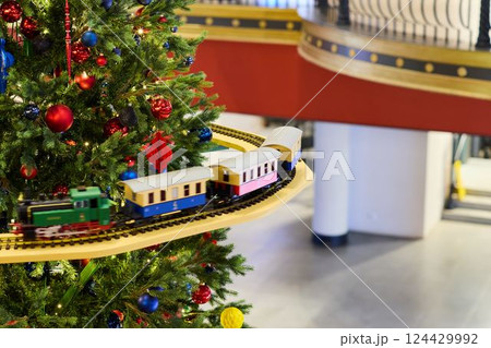 A beautifully festive train that is wonderfully decorated for the Christmas tree holiday season 124429992