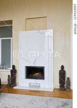 An Elegant Modern Fireplace featuring a Stunning Marble Surround and Intricate Statues An Elegant Modern Fireplace featuring a Stunning Marble Surround and Intricate Statues 124429997