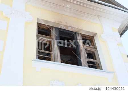 An abandoned building with burnt window frames offers unique charm for artistic photography An abandoned building with burnt window frames offers unique charm for artistic photography 124430021
