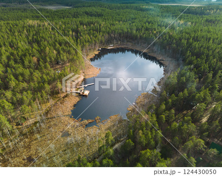 Beautiful and Serene Aerial View of a Forested Lake and the Surrounding Natural Wilderness 124430050