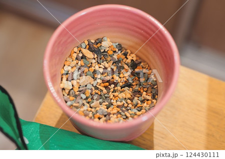 A Beautiful Arrangement of Colorful Decorative Gravel Placed in a Charming Pink Pot 124430111