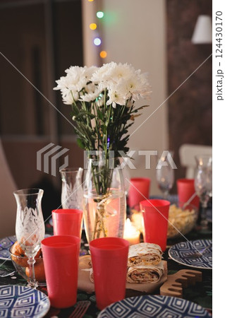Create an Elegant Table Setting that Incorporates Beautiful Flowers and Bold Red Accents Create an Elegant Table Setting that Incorporates Beautiful Flowers and Bold Red Accents 124430170