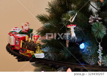 A Festive Christmas Train is Joyfully Decorating a Beautiful Christmas Tree with Cheer A Festive Christmas Train is Joyfully Decorating a Beautiful Christmas Tree with Cheer 124430207