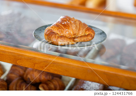 Showcase of traditional bakery shop with appetizing croissants Showcase of traditional bakery shop with appetizing croissants 124431766