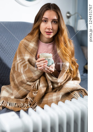 Woman feeling cold at home in winter Woman feeling cold at home in winter 124431767