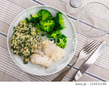 Dish of cod fillet, pearl barley and stewed broccoli 124432199