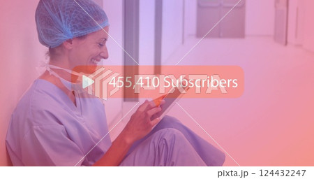 Medical professional using tablet over image showing 121,097 subscribers 124432247