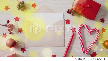 Christmas decorations with candy cane and envelope over festive stars image Christmas decorations with candy cane and envelope over festive stars image 124432291