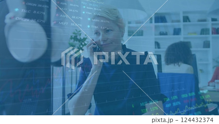 Financial data and stock market image over businesswoman talking on phone in office Financial data and stock market image over businesswoman talking on phone in office 124432374