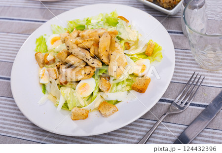 Portion of diet Caesar salad is served for lunch 124432396