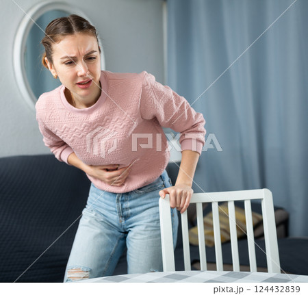 Young woman suffering from abdominal pain 124432839