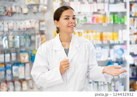 Portrait of positive female pharmacist who invites you to visit a pharmacy or healing cosmetics store 124432932