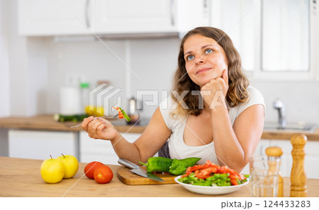 Female eating healthy salad with fresh vegetable Female eating healthy salad with fresh vegetable 124433283