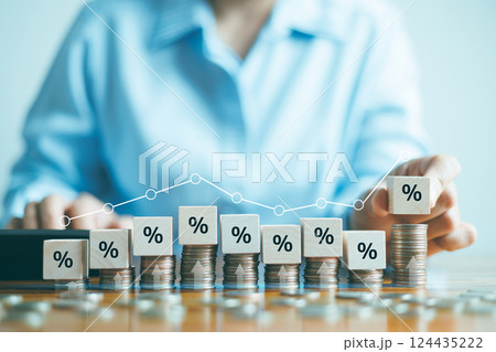 Interest rate and dividend concept, Hand putting wood cube block increasing on top stack money coin with icon percentage symbol, return on stocks and mutual funds, long term investment for retirement. 124435222