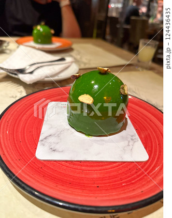 Modern dessert served on red plate in restaurant setting. Represents indulgence, culinary art, and the joy of shared dining experiences. Modern dessert served on red plate in restaurant setting. Represents indulgence, culinary art, and the joy of shared dining experiences. 124436435