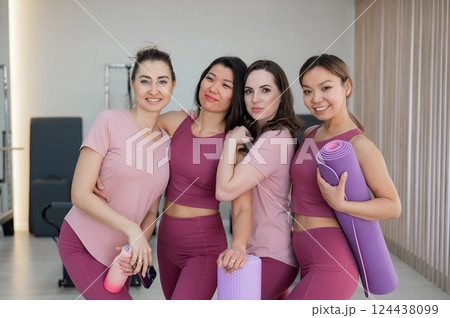 Two Caucasian and two Asian women after a Pilates workout.  124438099
