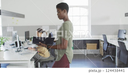 Image of financial data processing over biracial businesswoman in office 124438441