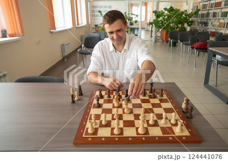 Caucasian man thinking about a chess move. Caucasian man thinking about a chess move. 124441076