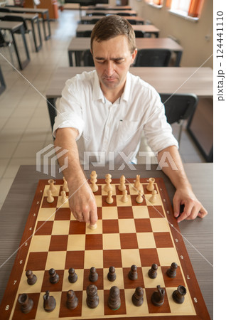 Portrait Caucasian man playing chess. Portrait Caucasian man playing chess. 124441110