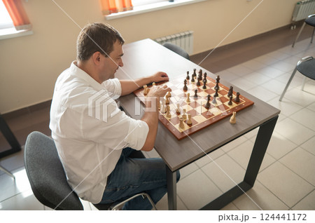 Portrait Caucasian man playing chess.  124441172