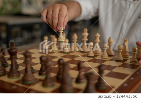 Close up of male hands playing chess. Close up of male hands playing chess. 124441550