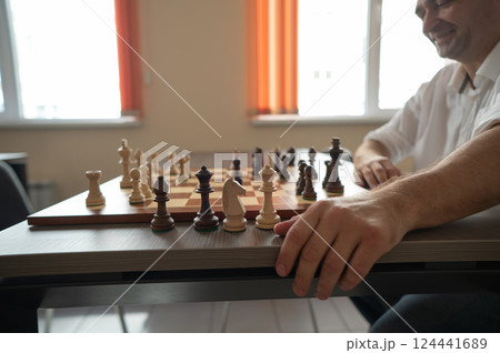 Caucasian man thinking about a chess move. Caucasian man thinking about a chess move. 124441689