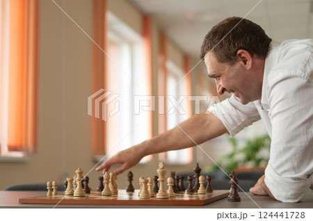 Caucasian man thinking about a chess move.  124441728