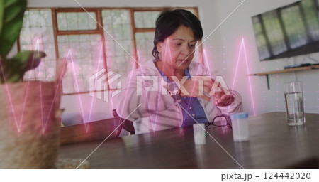 Image of cardiograph over senior biracial woman taking pills Image of cardiograph over senior biracial woman taking pills 124442020