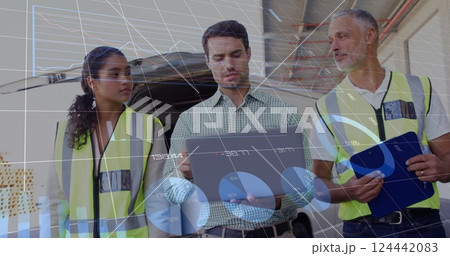 Image of data processing and diagrams over diverse colleagues using tablet at warehouse 124442083