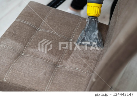 Dry cleaning a fabric chair.  124442147