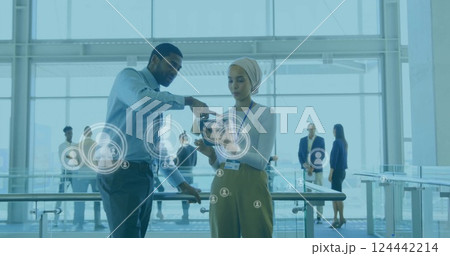 Image of people icons and data processing over diverse business people in office Image of people icons and data processing over diverse business people in office 124442214