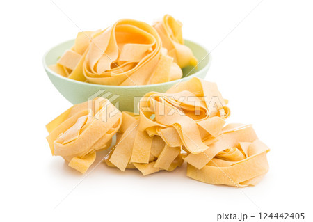 Italian pasta tagliatelle. Uncooked noodle pasta isolated on white background. 124442405