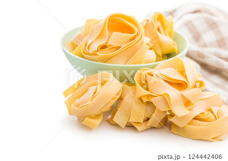 Italian pasta tagliatelle. Uncooked noodle pasta isolated on white background. 124442406