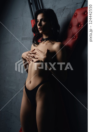 Woman Posing in Studio With Red Upholstery prepared for sexual bdsm game Woman Posing in Studio With Red Upholstery prepared for sexual bdsm game 124442550
