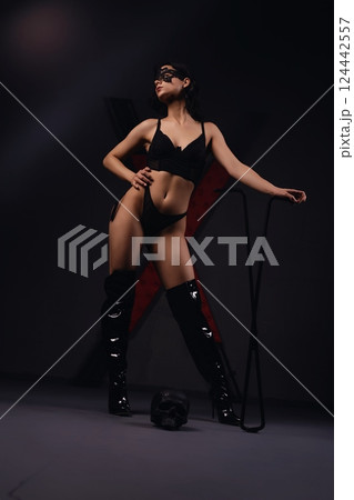 Woman in Black Lingerie Posing With Whip prepared for sexual bdsm game 124442557