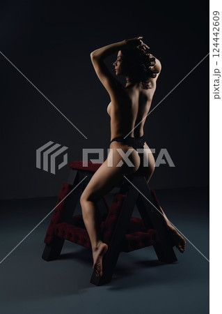 Woman in Black Lingerie Sitting on Stool prepared for bdsm game Woman in Black Lingerie Sitting on Stool prepared for bdsm game 124442609